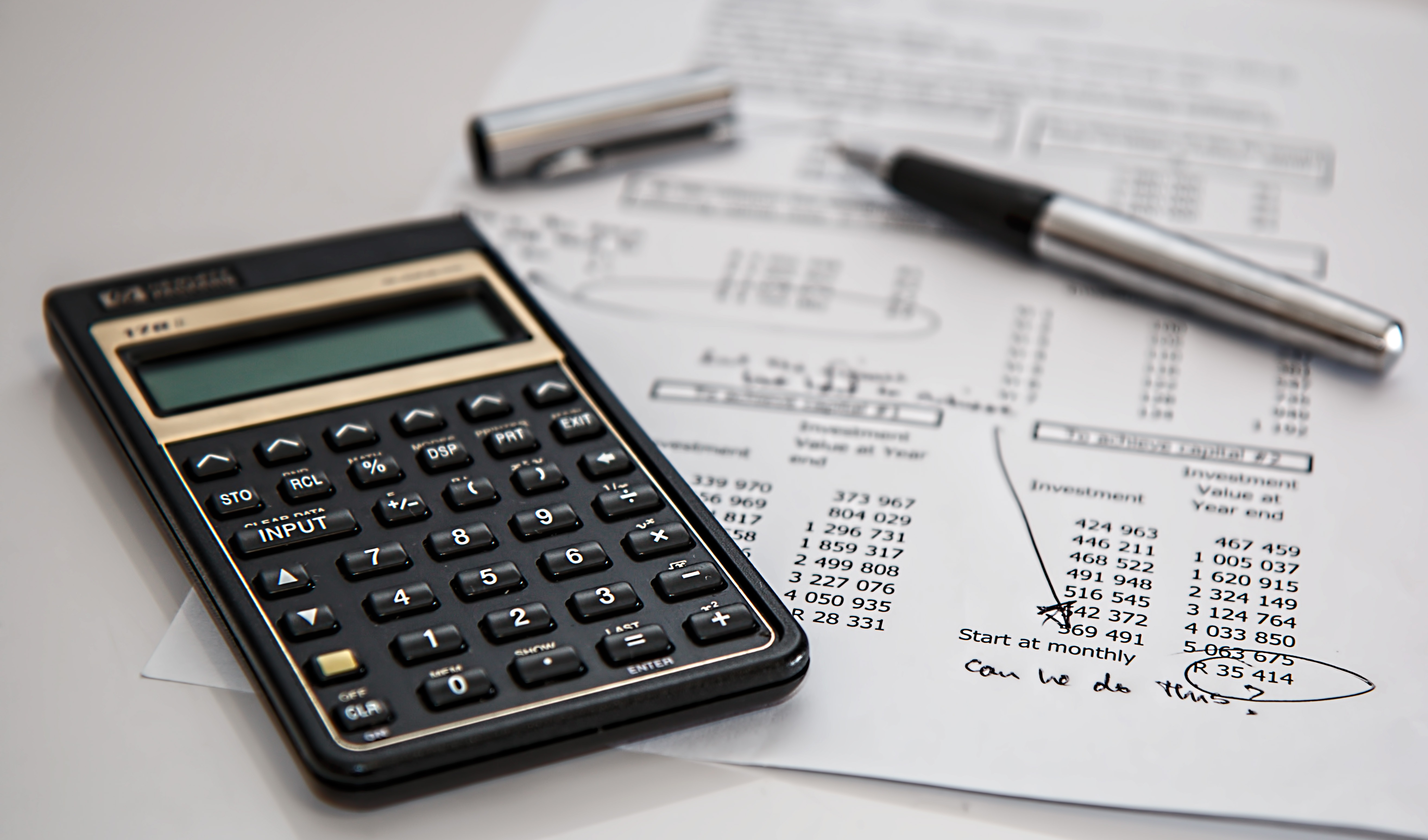 Calculator and handwritten ledger figures